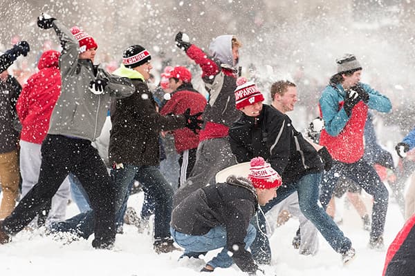 Mass of students having a snowball fight on Bascom Hill
