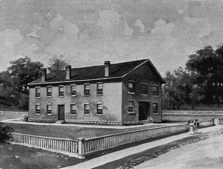 Black and white illustration of a small two-story brick building where UW’s first-ever class was held.