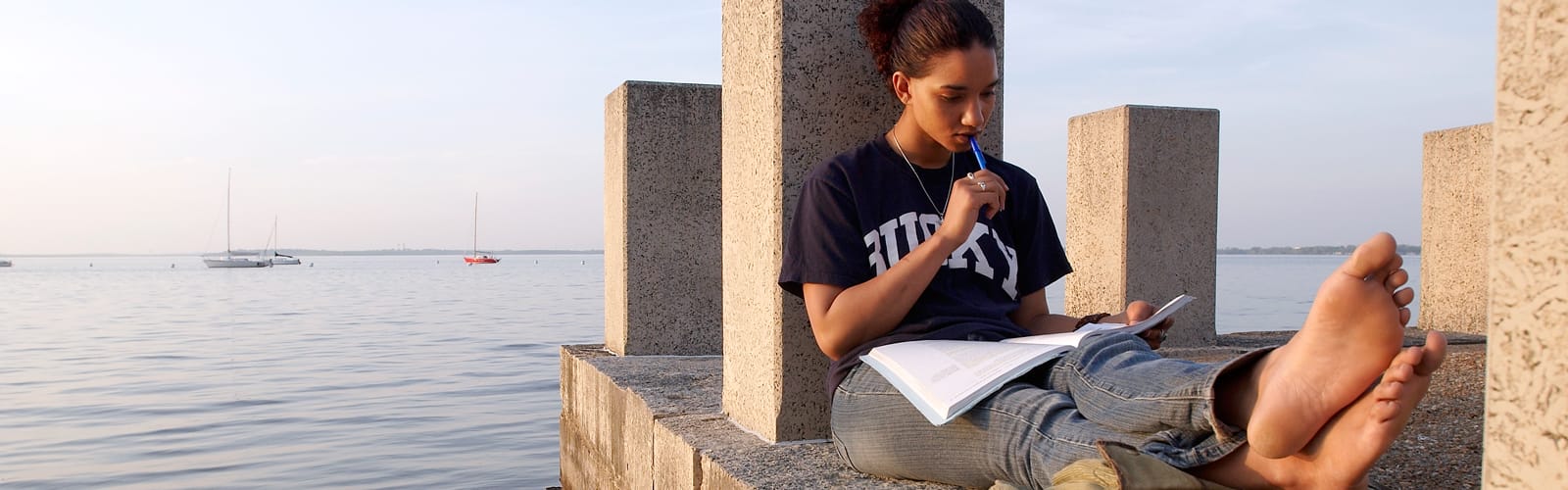Student sitting alongside Lake Mendota