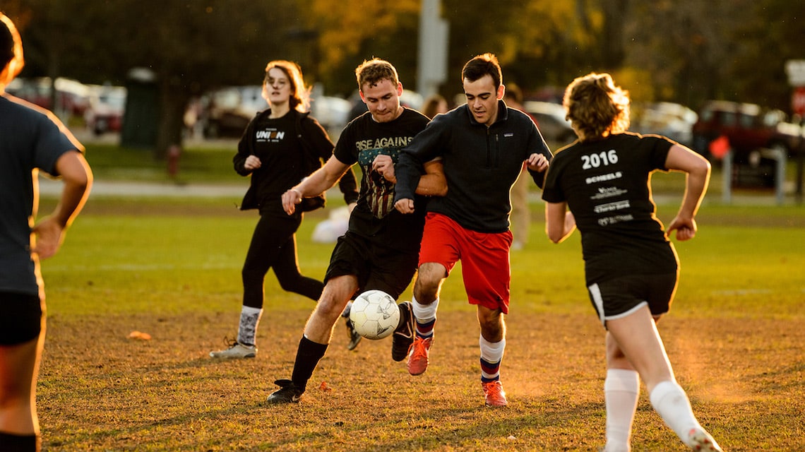 Students play a game of soccer on the outdoor fields