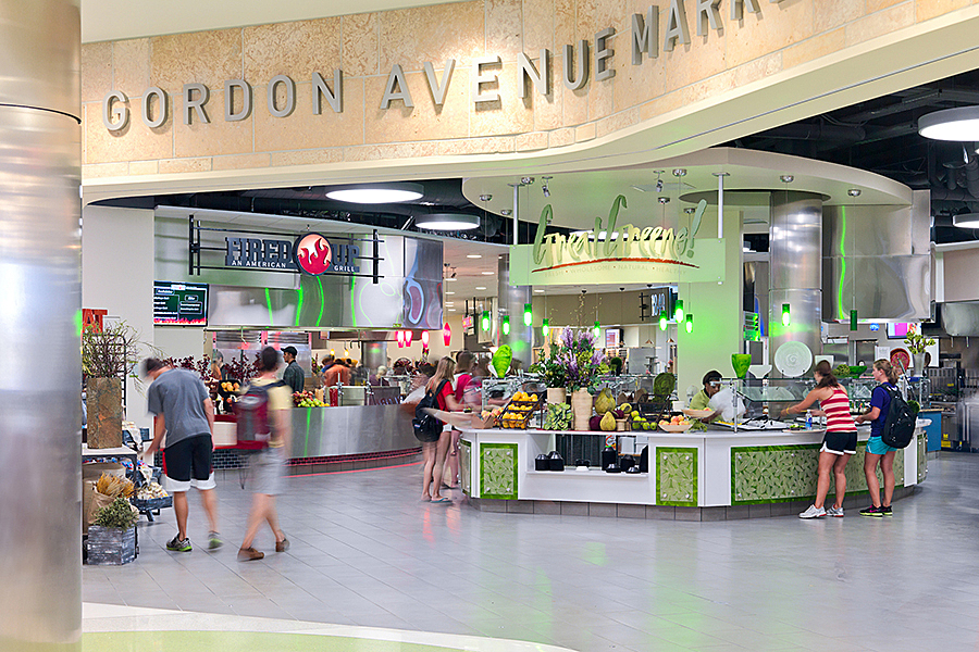 People browsing food options near entrance to Gordon Avenue Market