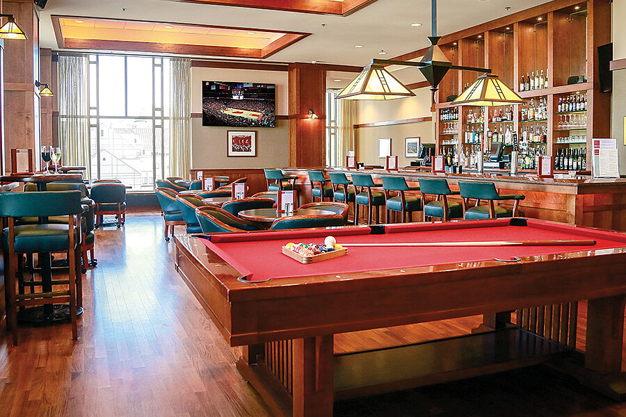 Pub-style bar with seating, pool table and TV. 