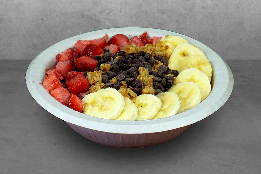 Bowl filled with sliced strawberries, bananas and acai.