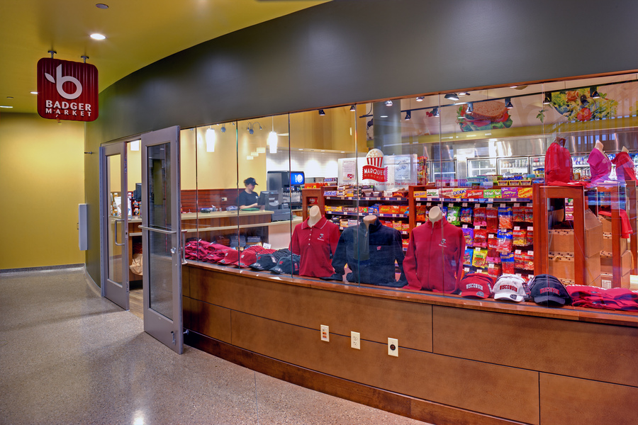 Apparel and merchandise on display through glass windows at Badger Market.