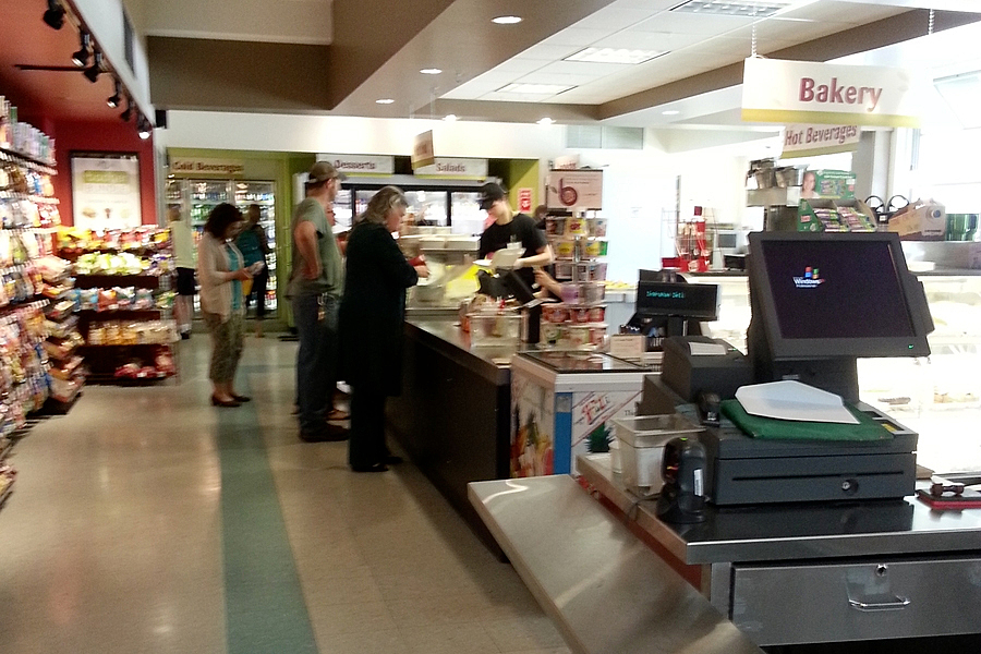 People standing in line at sales counter.