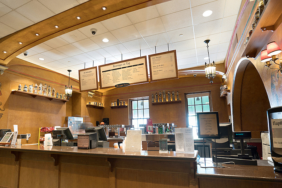 Sales counter with beer and beverages menu fixed to ceiling. 