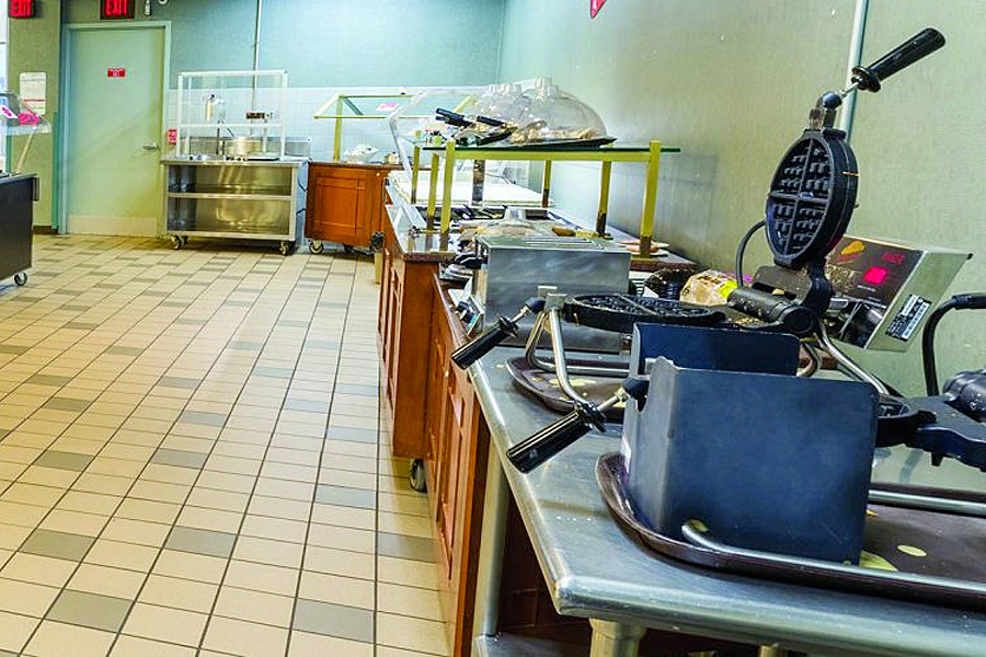 Row of self-serve food stations at Lowell Market, including a waffle maker. 