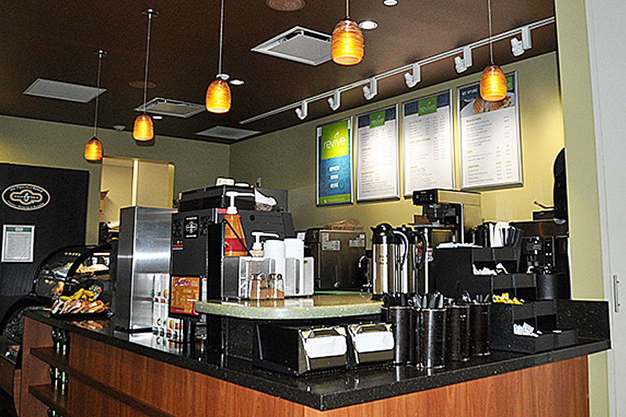 Coffee creamers, napkins and utensils on sales counter.