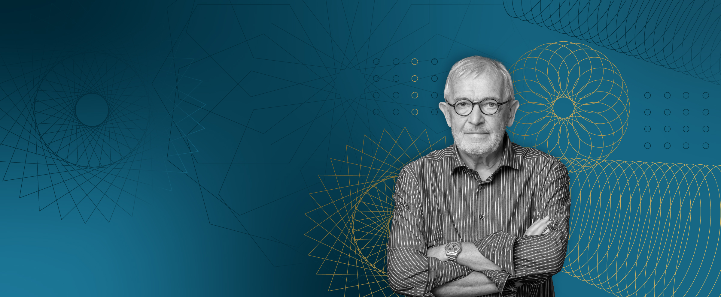 A black-and-white photo of Francis Halzen standing with his arms crossed against a teal background featuring gold geometric line patterns.
