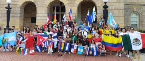 Students in front of Bascom Hall holding colorful flags.