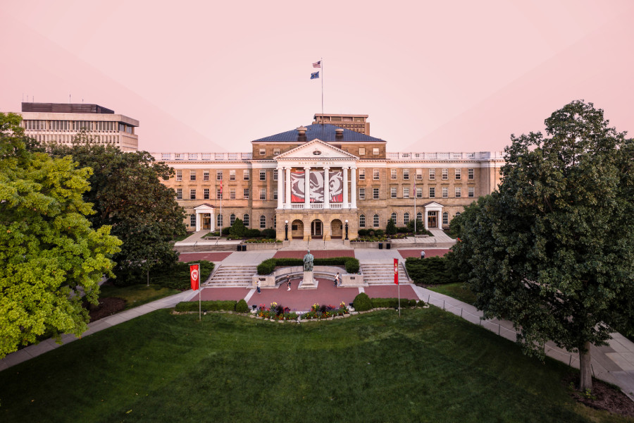 Bascom Hall building on the UW–Madison campus with a pink sky and trees