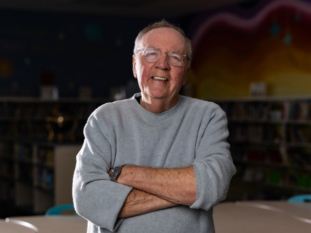 James Patterson smiles in a school classroom