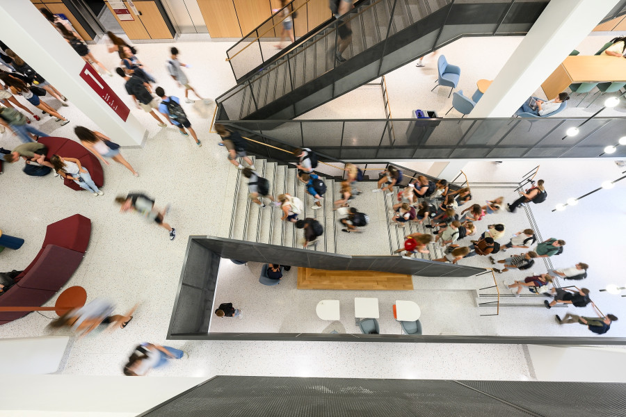 Students walk to class in a view from the top of the stairs in Irving and Dorothy Levy Hall.