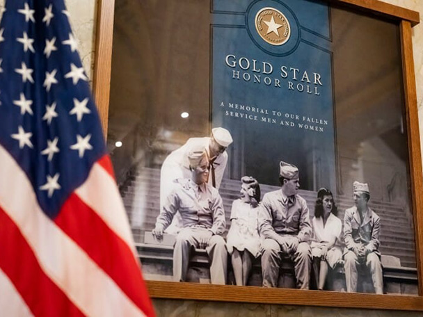 Closeup of a video display of service members in uniform