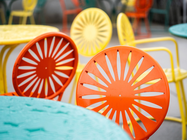 A close-up of orange, red and yellow sunburst chairs at the Memorial Union Terrace.