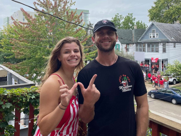 Bridget and Charlie Berens make a W sign with their thumbs and forefingers.