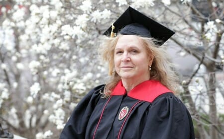 Dawn Proctor wears a UW–Madison commencement robe and mortar board.