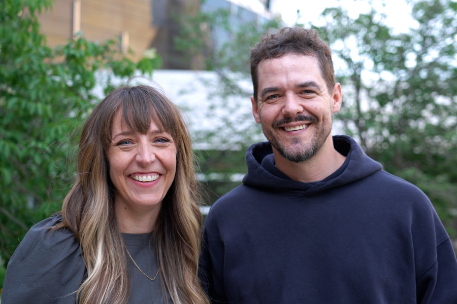 Meagan Hahn and Shawn Wiederhoeft stand together outdoors, smiling.