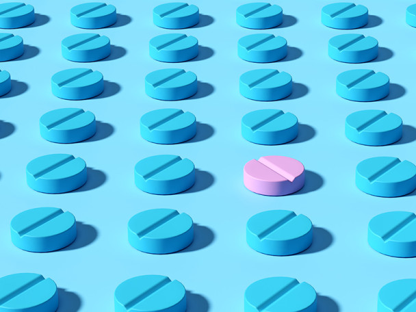 Illustration of rows of pill tablets, all in the color blue except for one in pink.