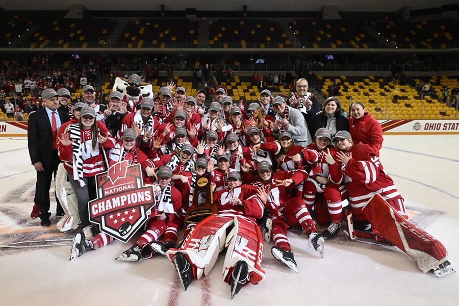 The Wisconsin Women's Hockey team poses for a team photo together on the ice after winning the 2023 NCAA Women's Ice Hockey National Championships at AMSOIL Arena in Duluth, Minnesota.