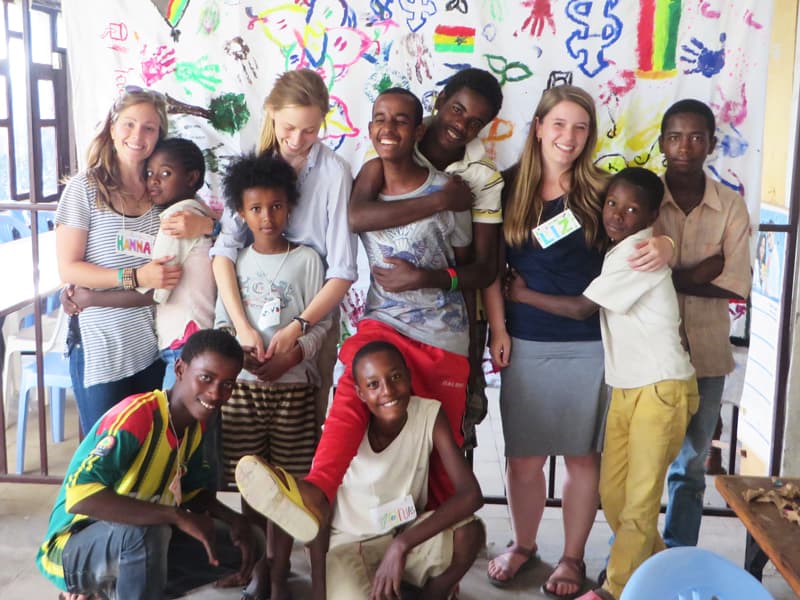 A group of young volunteers and children