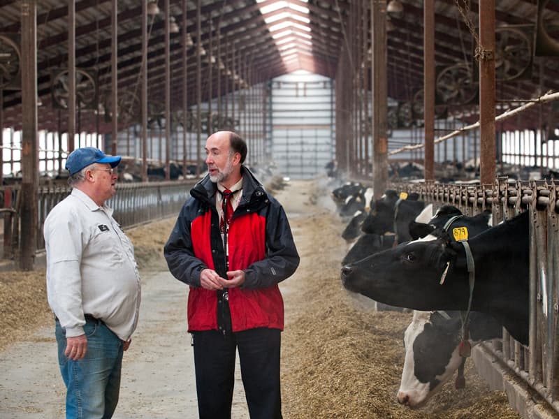 UW School of Medicine and Public Health faculty member Byron Crouse talks with a dairy farmer about health insurance