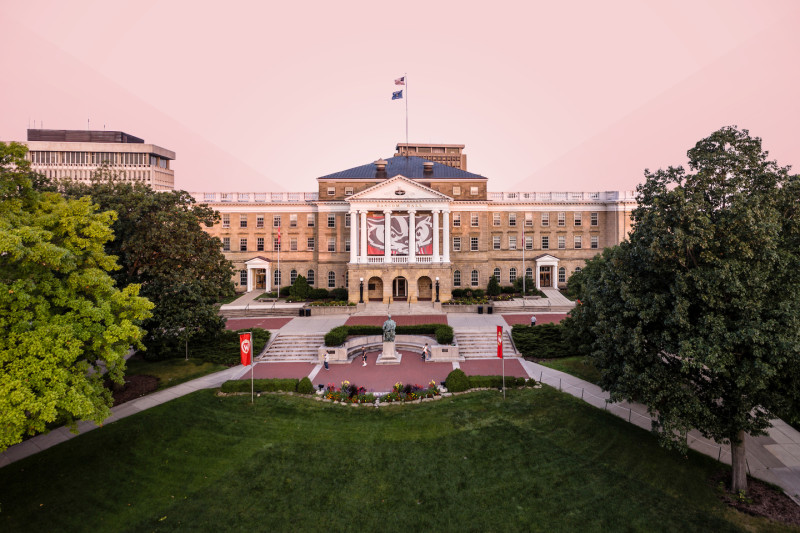 Bascom Hall building on the UW–Madison campus with a pink sky and trees