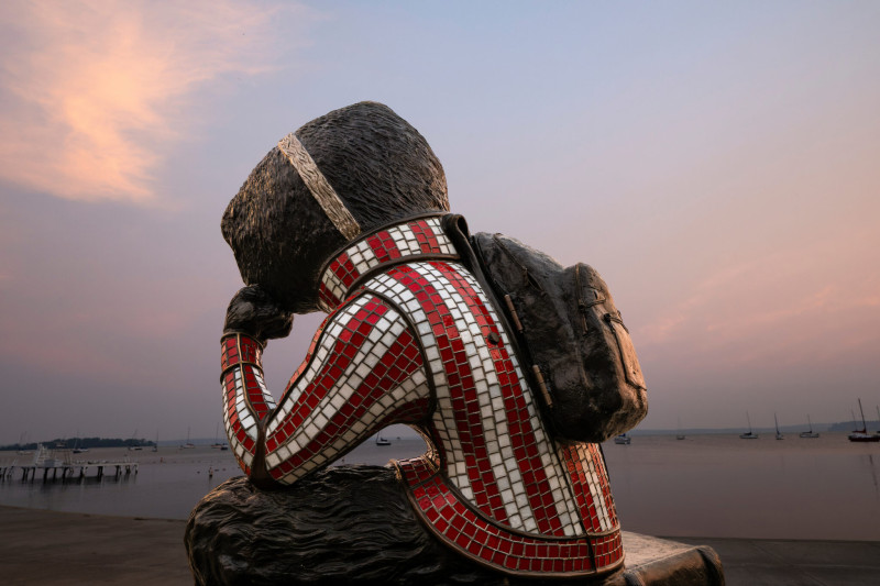 Smoke-filled air surrounds a statue of Bucky Badger overlooks Lake Mendota.