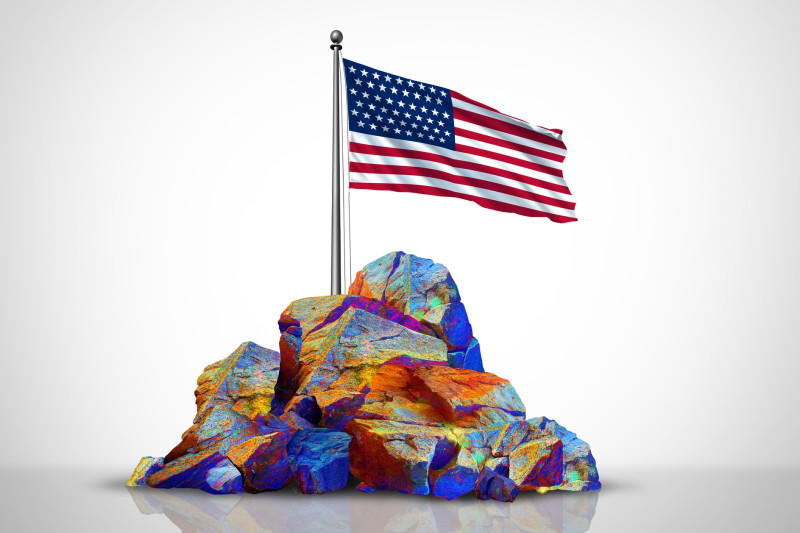 A conceptual rendering of rare earth elements in a rock pile, with a U.S. flag on top of it.