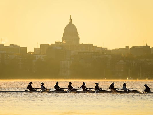 Crew team on Lake Mendota with capitol building in background