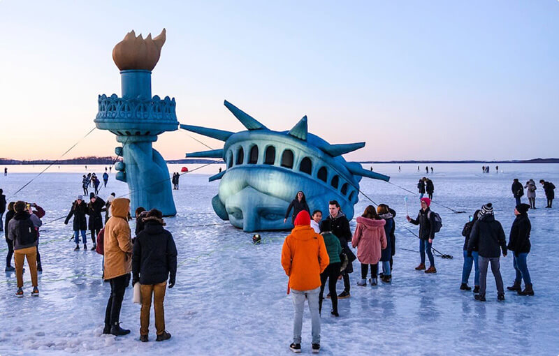 Statue of Liberty rising from a frozen Lake Mendota